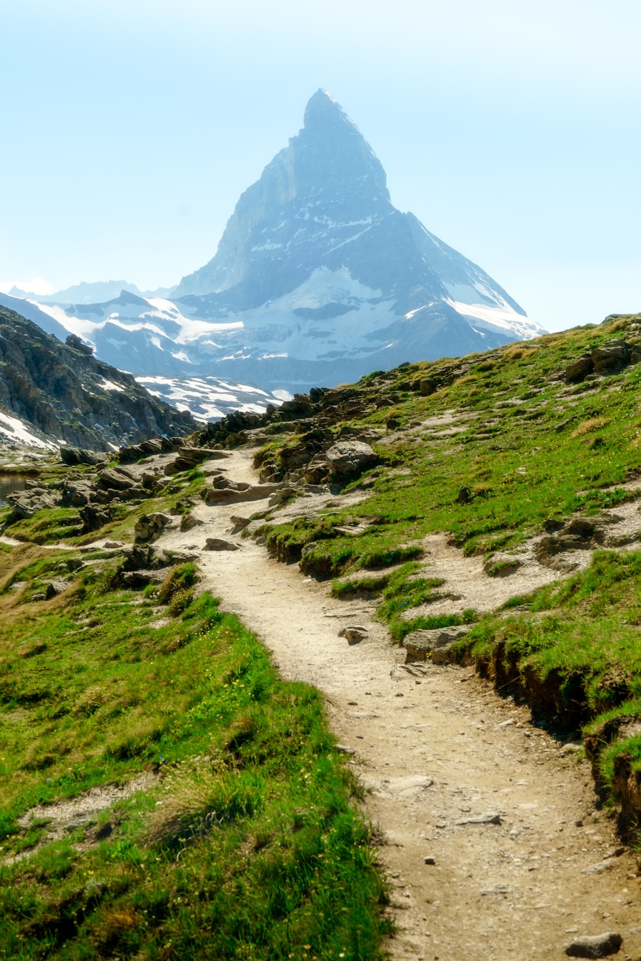 Mountain trail leading toward a snow-capped peak
